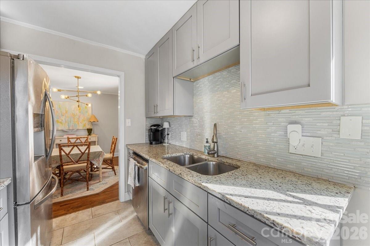 4922 Valley Stream Road Charlotte, NC 28209 - Photo 18 of 33 a kitchen with a sink and cabinets