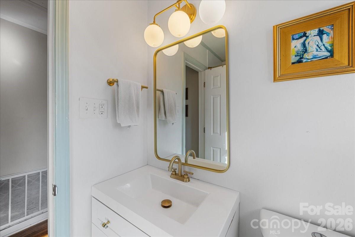 4922 Valley Stream Road Charlotte, NC 28209 - Photo 21 of 33 a bathroom with a sink mirror and vanity