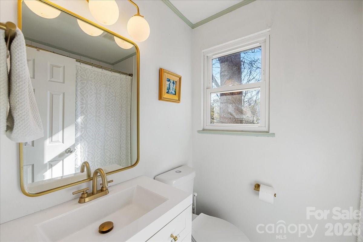 4922 Valley Stream Road Charlotte, NC 28209 - Photo 22 of 33 a bathroom with a sink and a mirror