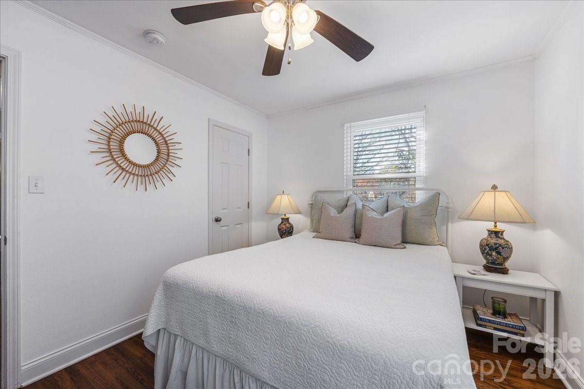 4922 Valley Stream Road Charlotte, NC 28209 - Photo 23 of 33 a bedroom with a bed and a chandelier