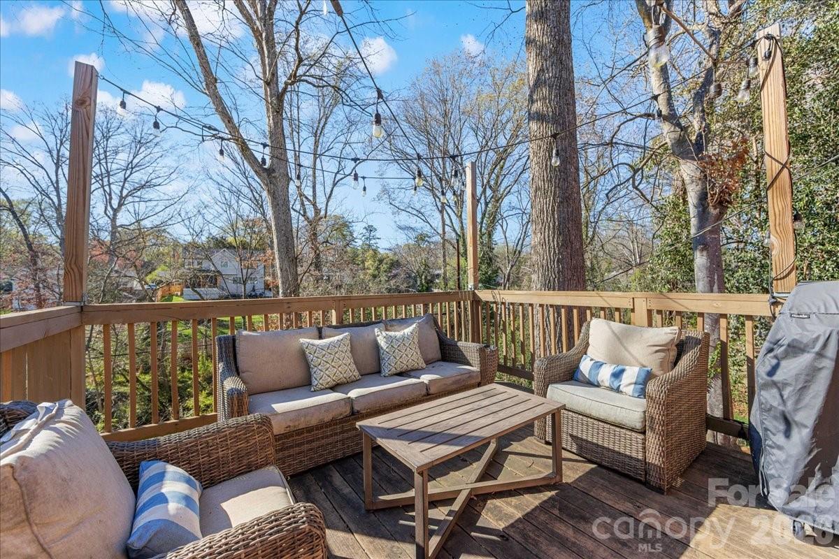 4922 Valley Stream Road Charlotte, NC 28209 - Photo 28 of 33 a balcony with wooden floor and outdoor seating