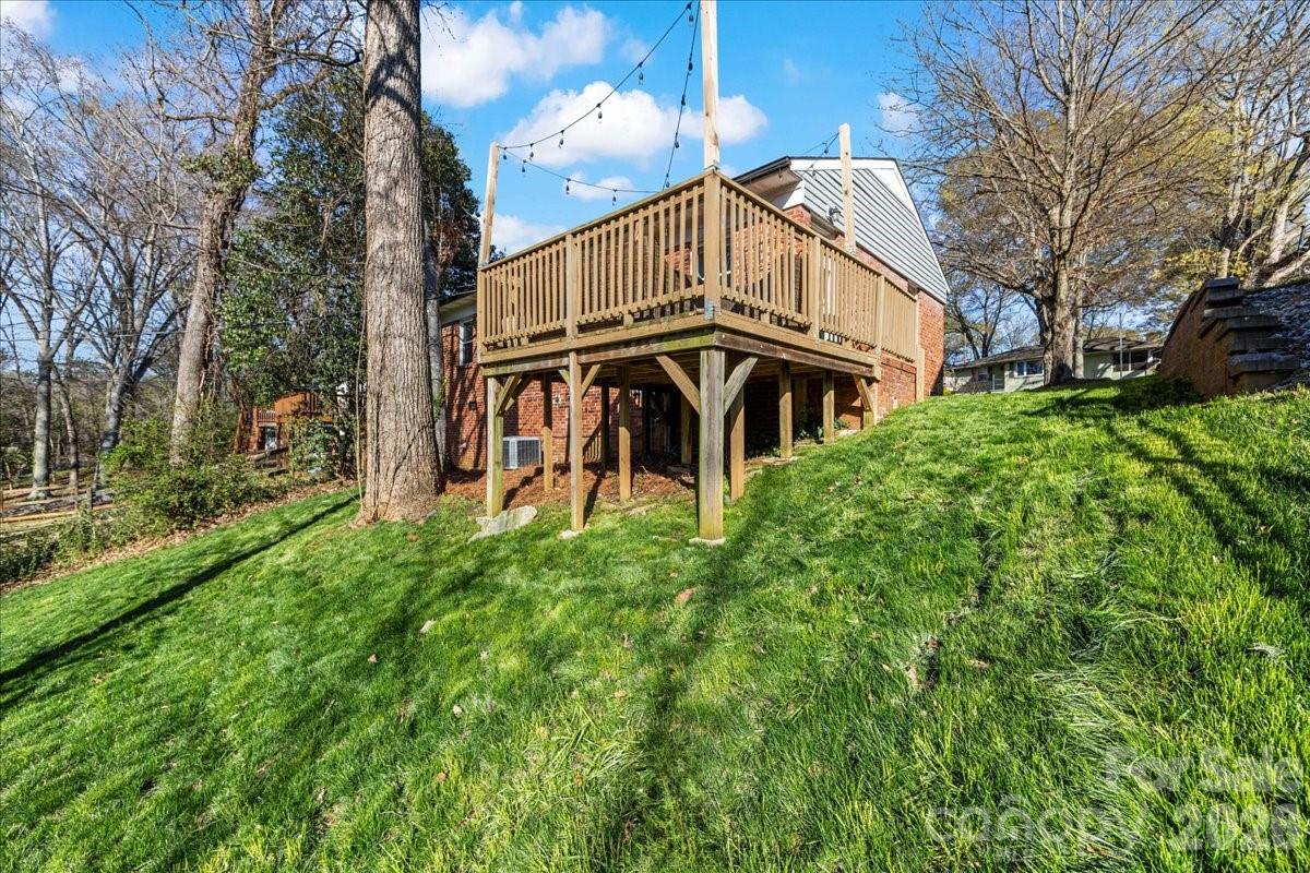 4922 Valley Stream Road Charlotte, NC 28209 - Photo 31 of 33 a view of a house with a yard