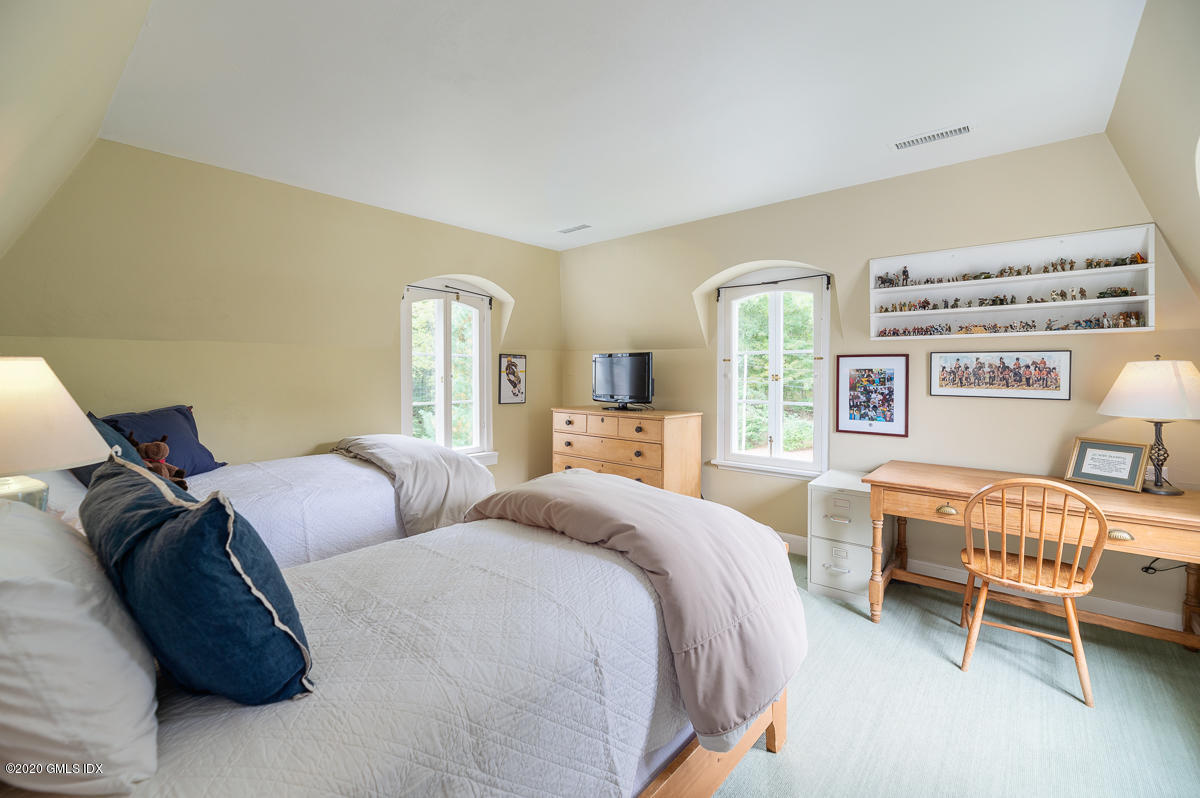 10 Frost Road Greenwich, CT 06830 - Photo 19 of 24 a bedroom with a bed and a chair