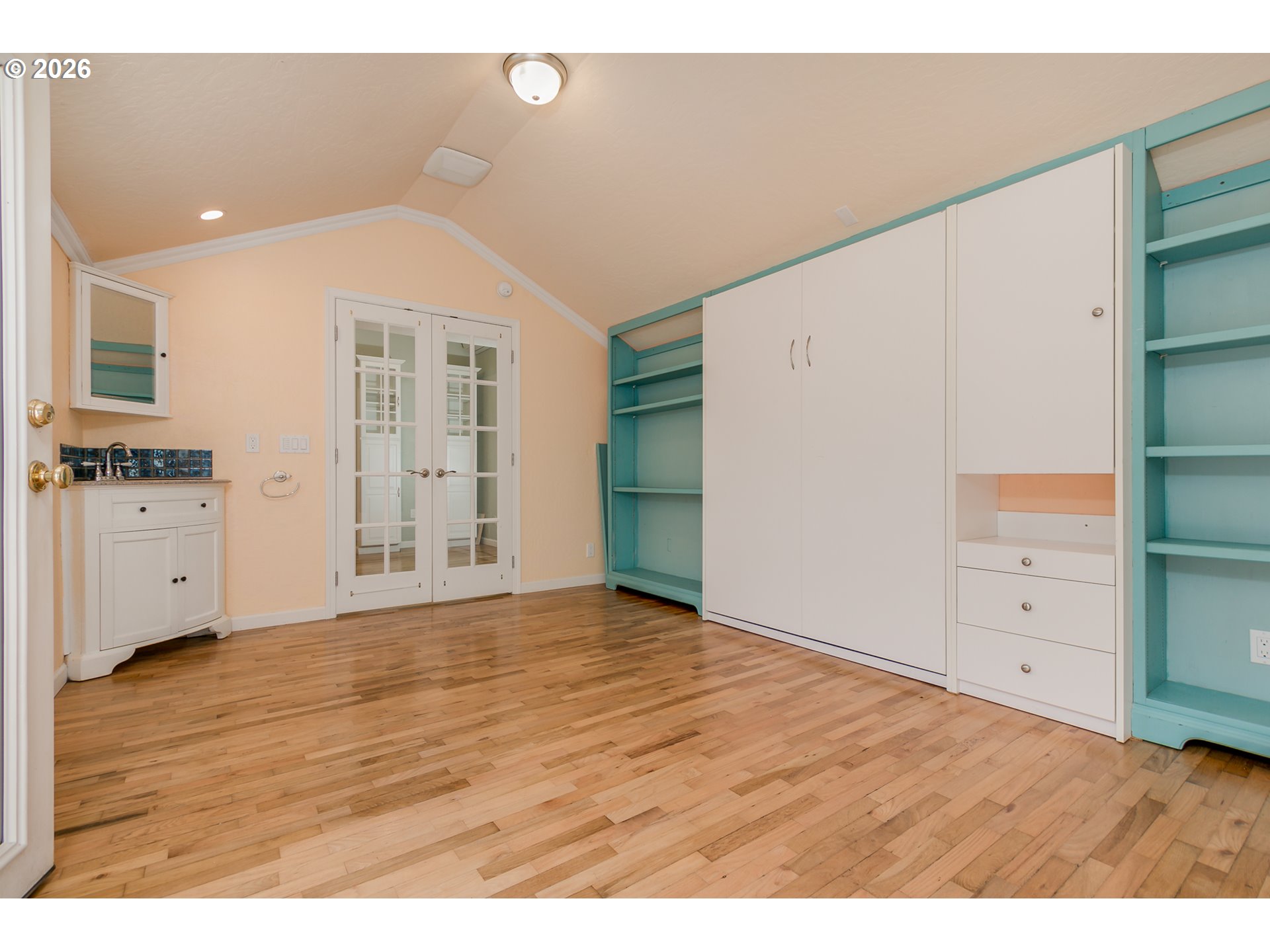 715 Ellsworth Street Eugene, OR 97402 - Photo 15 of 26 a view of an empty room with cabinet and wooden floor