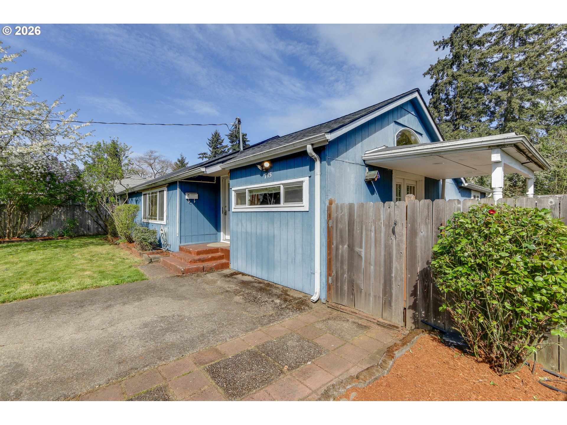 715 Ellsworth Street Eugene, OR 97402 - Photo 3 of 26 a front view of a house with a yard and garage