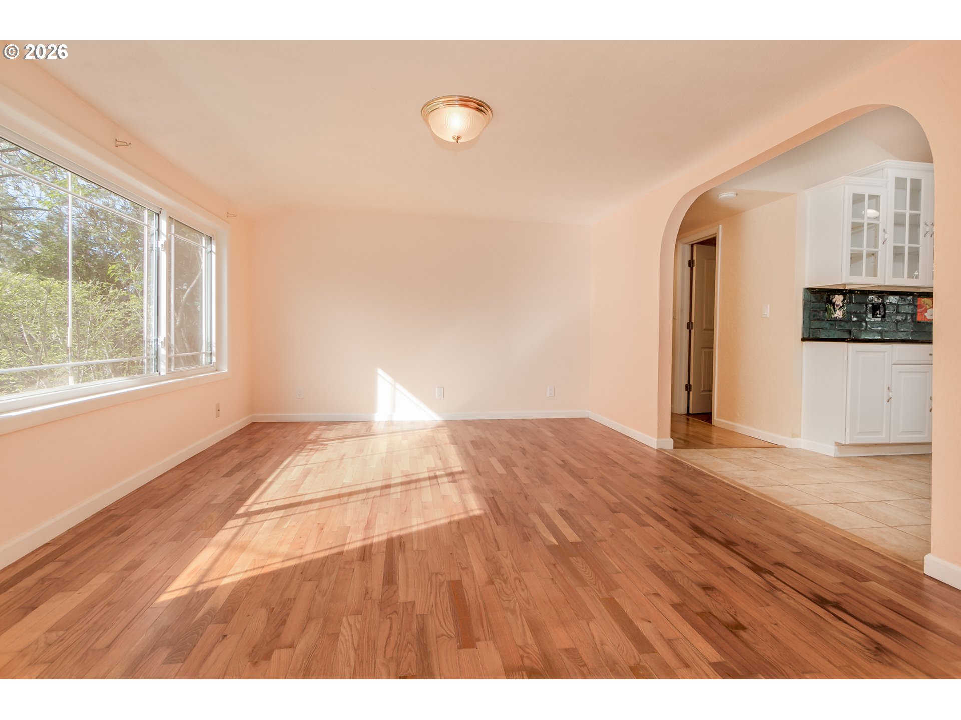 715 Ellsworth Street Eugene, OR 97402 - Photo 5 of 26 a view of empty room with wooden floor and fan