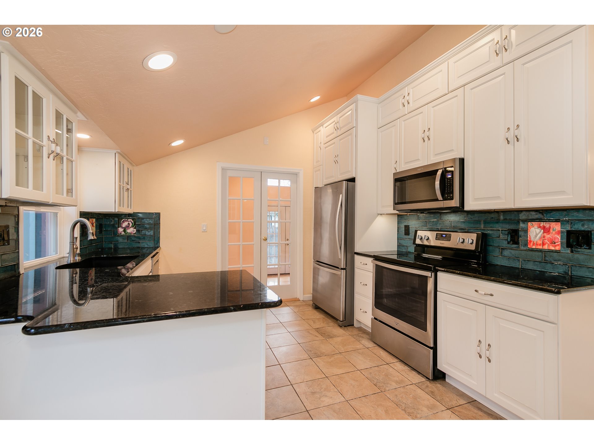 715 Ellsworth Street Eugene, OR 97402 - Photo 7 of 26 a kitchen with stainless steel appliances granite countertop a stove a sink and a microwave