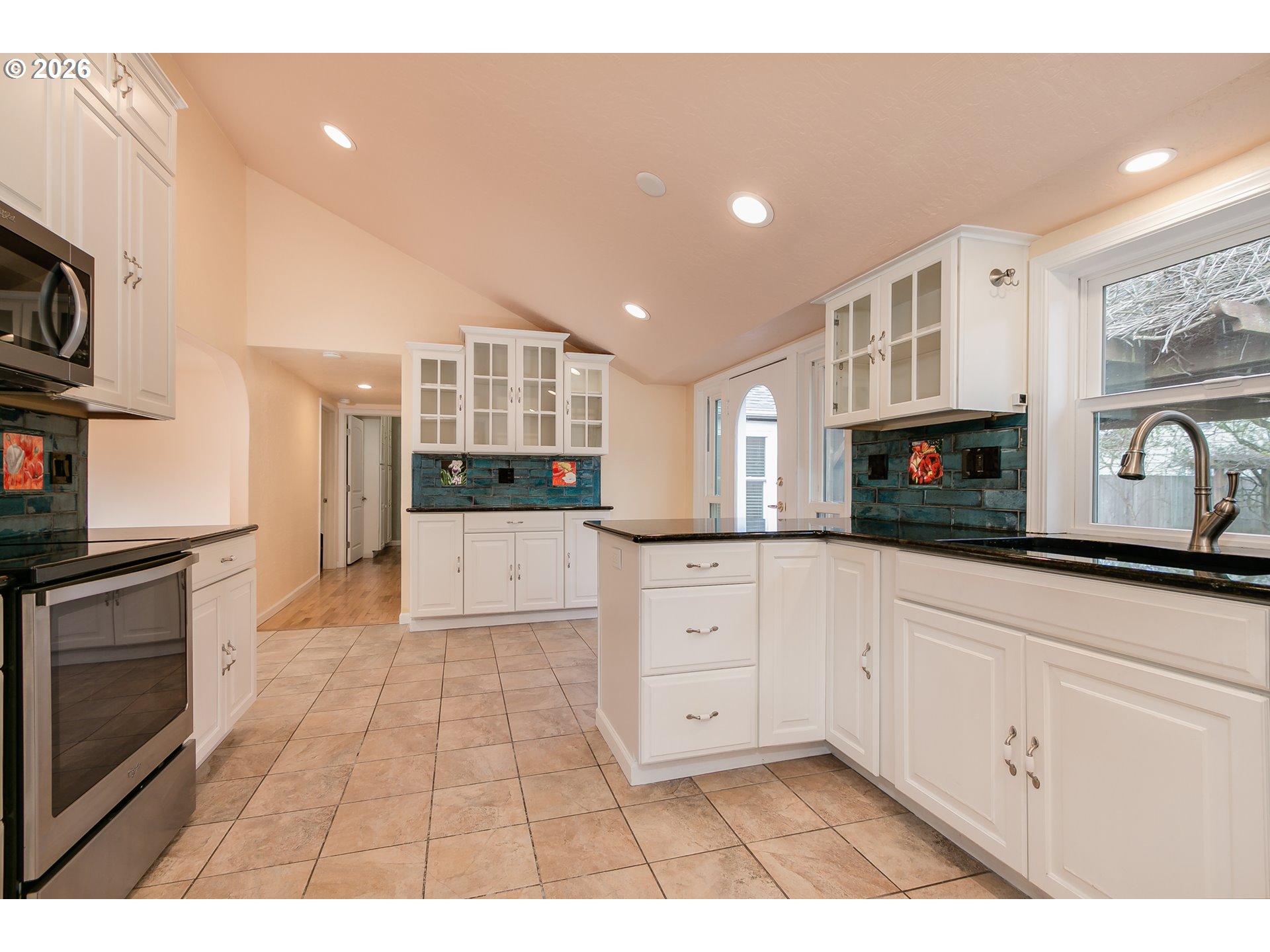 715 Ellsworth Street Eugene, OR 97402 - Photo 8 of 26 a kitchen with stainless steel appliances kitchen island granite countertop a refrigerator and a stove top oven