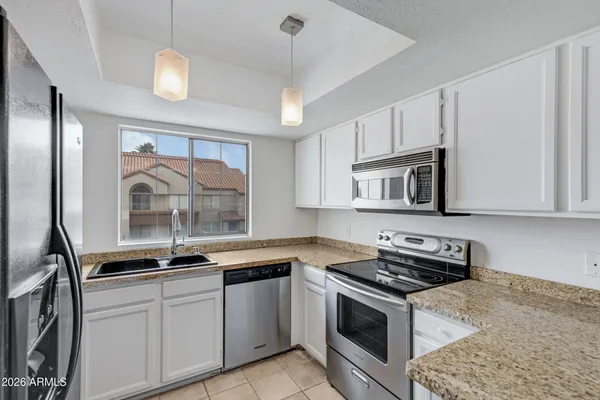 a kitchen with a stove microwave and sink