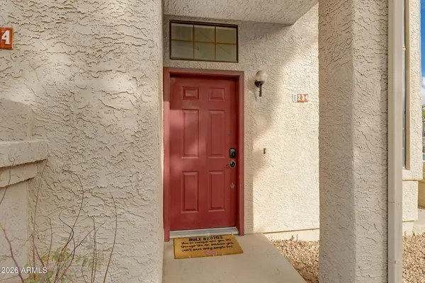 a view of a bedroom with wooden floor and cabinet