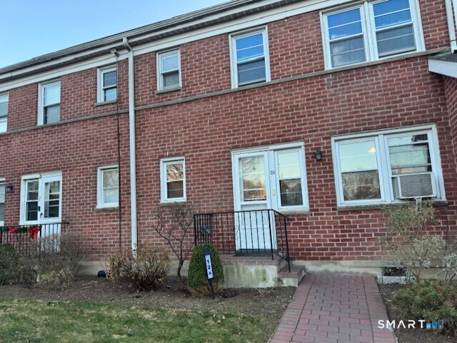 236 Glenbrook Road, Unit 12A Stamford, CT 06906 - Photo 2 of 18 a brick building that has a lots of windows in it