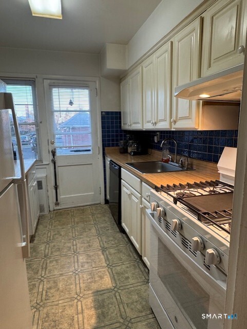 236 Glenbrook Road, Unit 12A Stamford, CT 06906 - Photo 4 of 18 a kitchen with stainless steel appliances granite countertop a stove a sink and a refrigerator