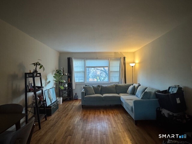 236 Glenbrook Road, Unit 12A Stamford, CT 06906 - Photo 6 of 18 a living room with furniture and a flat screen tv