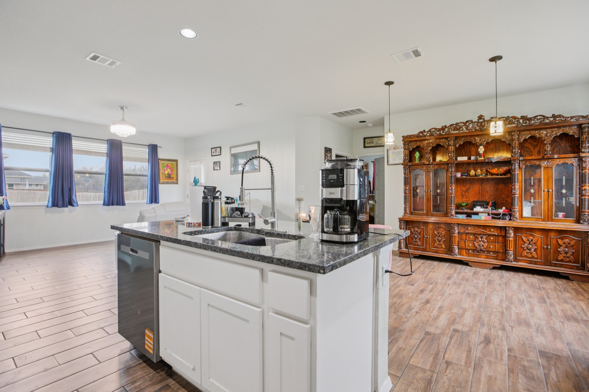 119 Saranac Drive Elgin, TX 78621 - Photo 12 of 41 a view of a kitchen with kitchen island a sink wooden floor and window