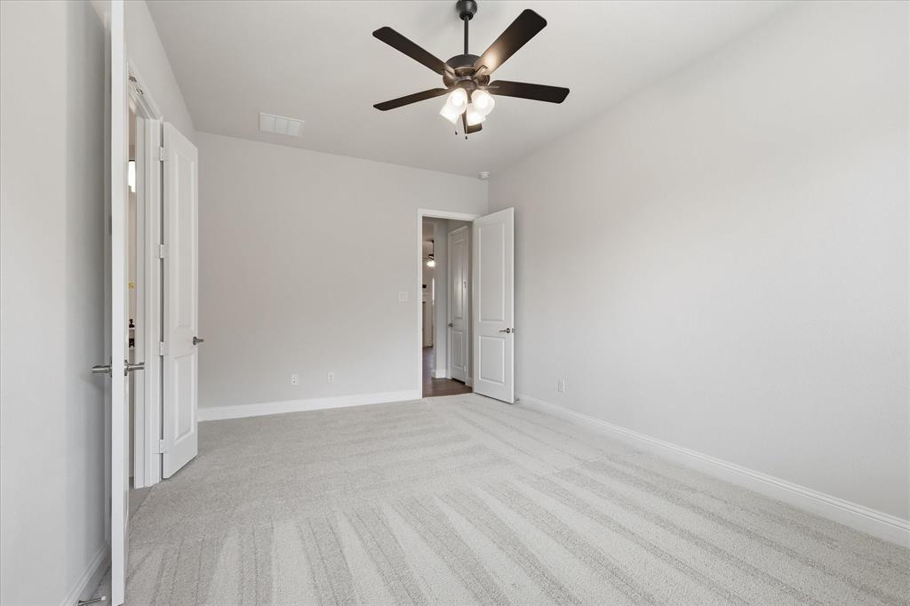 4017 Alpine Street Midlothian, TX 76065 - Photo 19 of 37 Spacious room featuring light-toned carpeting, a ceiling fan with integrated lighting, white baseboards, and neutral wall tones