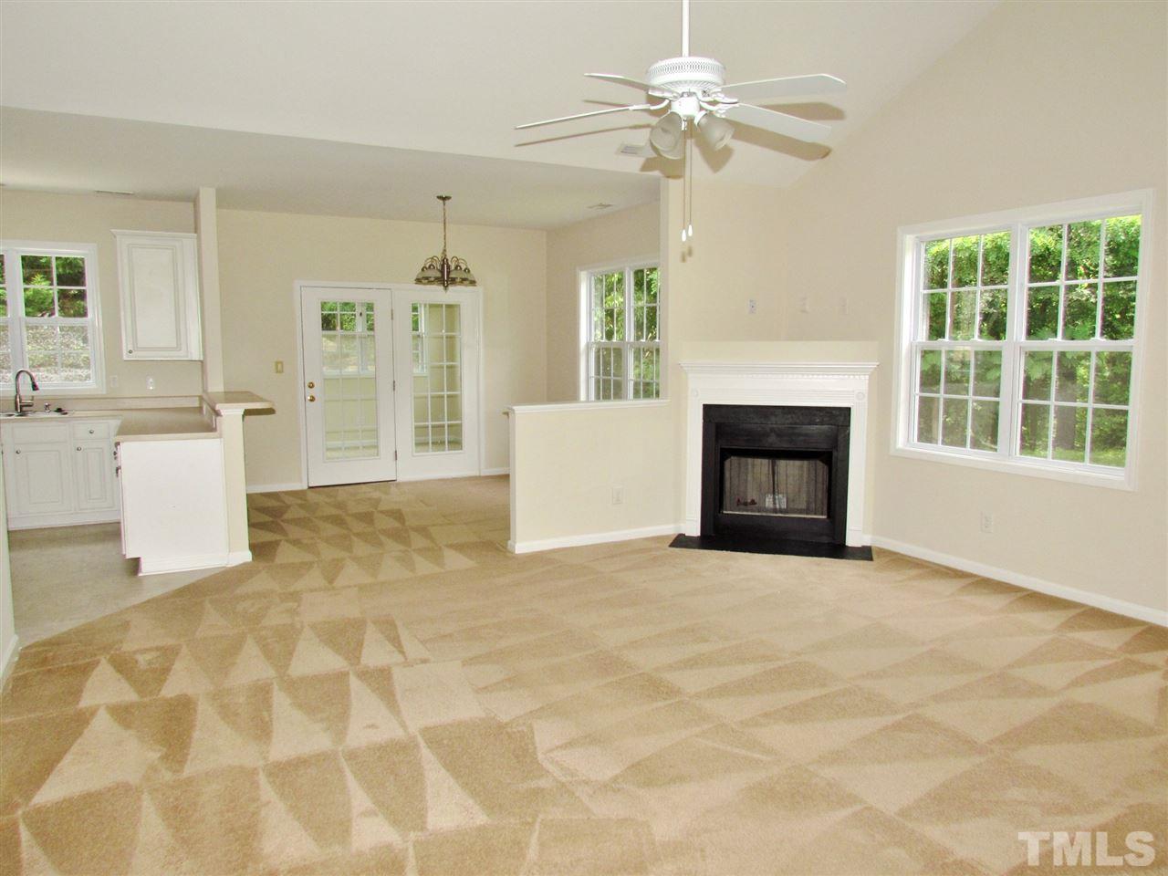2700 Andover Glen Road Raleigh, NC 27604 - Photo 7 of 25 a view of an empty room with a fireplace and a window