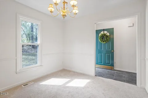 an empty room with windows and entrance