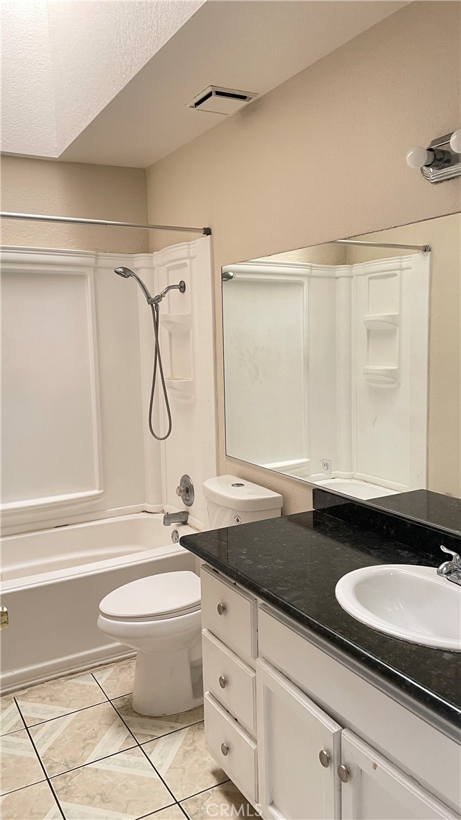 14425 Manzano Road Victorville, CA 92392 - Photo 19 of 21 a bathroom with a granite countertop sink toilet and shower
