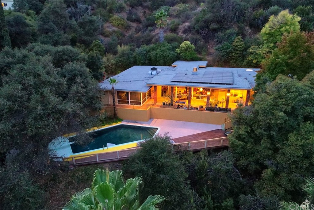 an aerial view of house with outdoor space swimming pool and outdoor seating