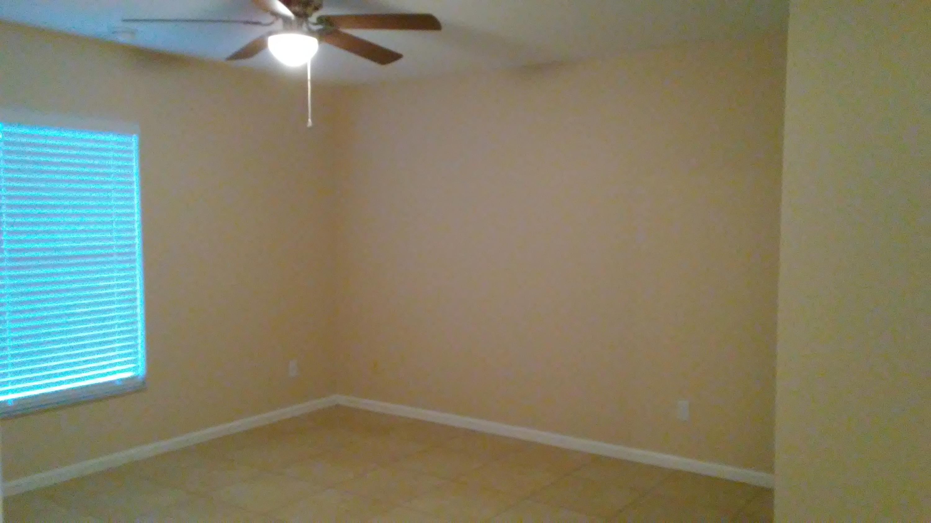 832 Southwest Duncan Terrace Port St. Lucie, FL 34953 - Photo 11 of 37 an empty room with a window and a fan