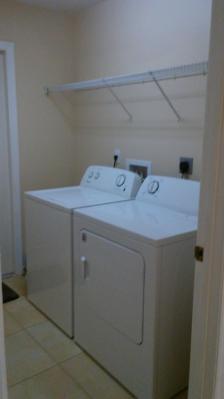 832 Southwest Duncan Terrace Port St. Lucie, FL 34953 - Photo 24 of 37 a utility room with dryer and washer