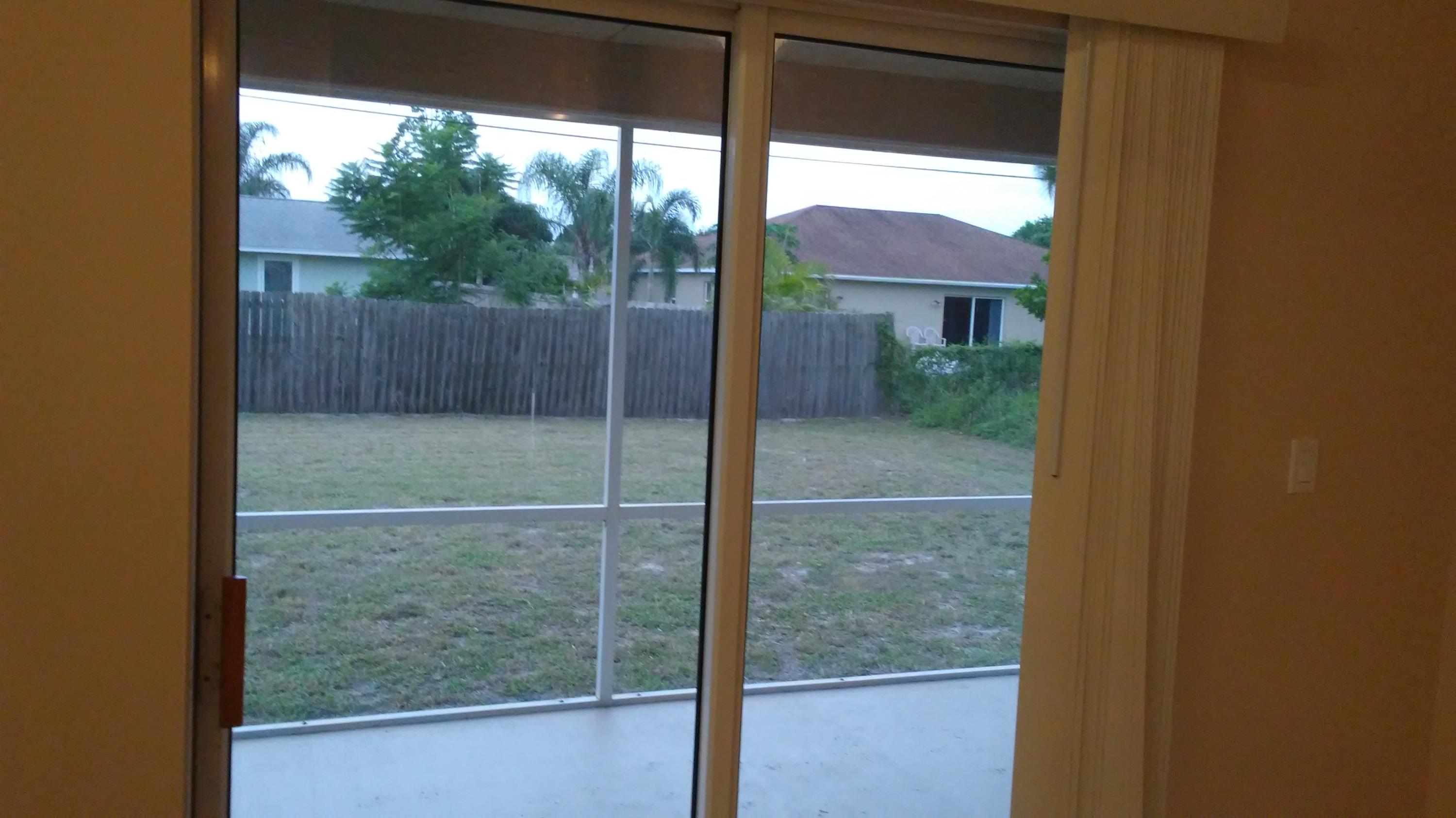 832 Southwest Duncan Terrace Port St. Lucie, FL 34953 - Photo 32 of 37 a bathroom with a glass door and shower
