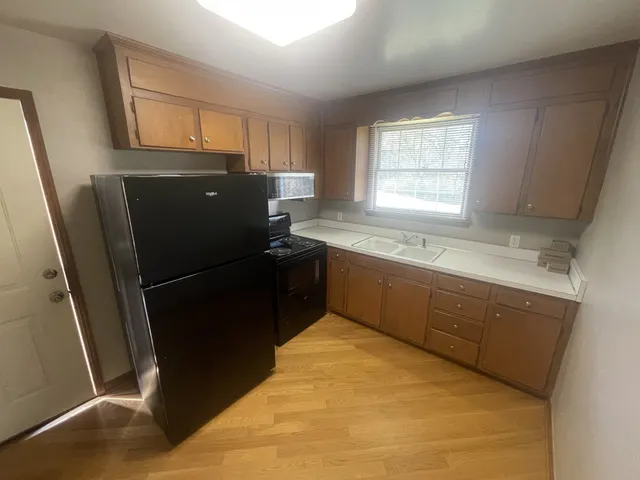 a kitchen with a refrigerator sink and window