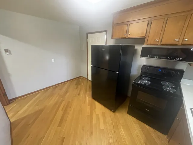 a kitchen with a refrigerator and a stove