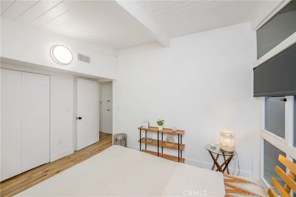 a bedroom with furniture and a flat screen tv