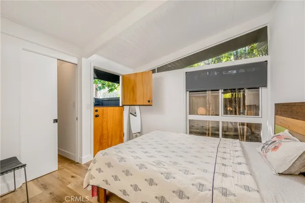 a bedroom with a bed and a window