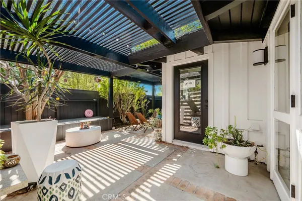 a view of a patio with table and chairs and potted plants