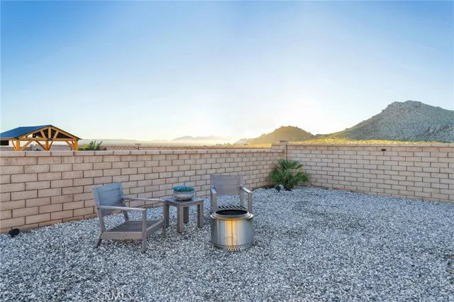 a view of a terrace with lawn chairs