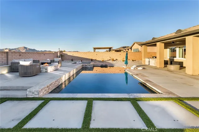 a view of a swimming pool with lounge chairs