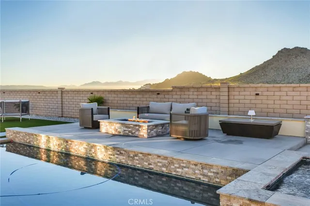 a living room with a patio furniture and a fireplace