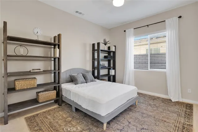a bedroom with a bed and window