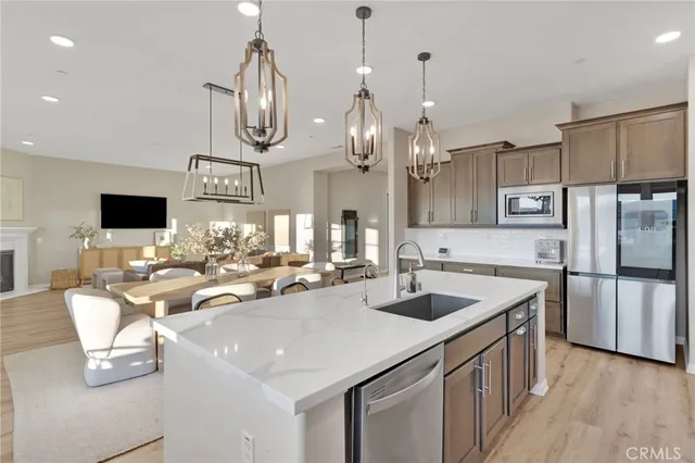 a bedroom with a large bed chandelier and a window