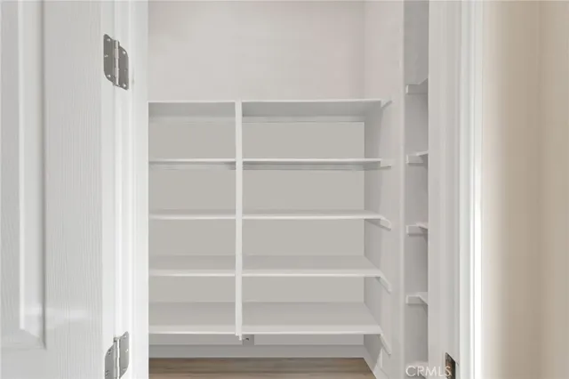 a view of a dining room with furniture wooden floor fireplace and a chandelier