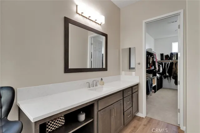 a kitchen with stainless steel appliances granite countertop a sink a stove a refrigerator cabinets and chairs