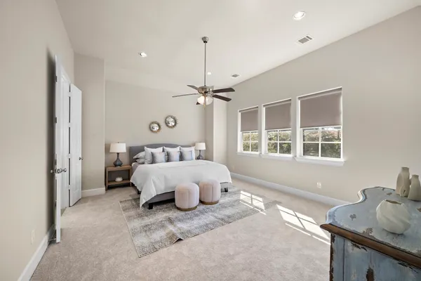 a spacious bedroom with a bed and window