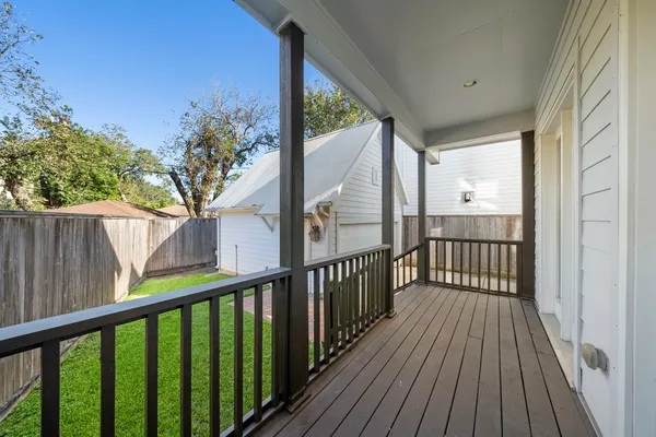 a view of a balcony with wooden floor