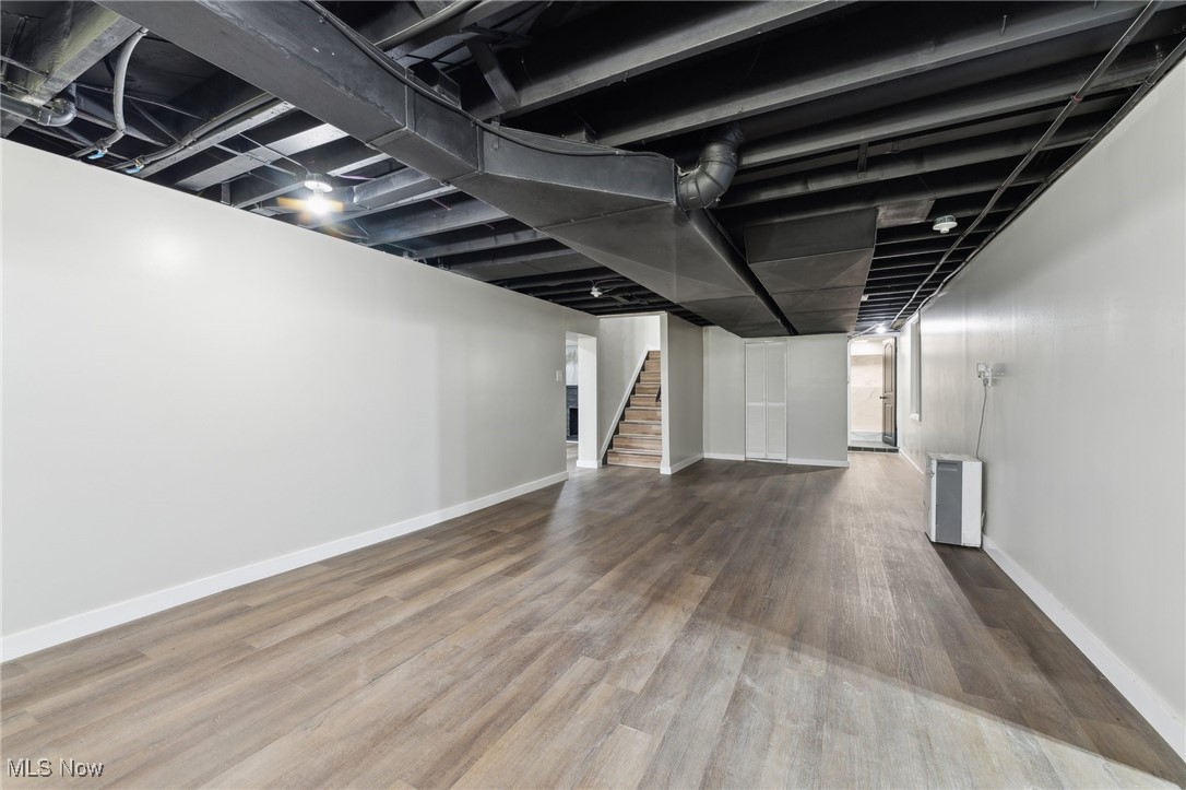 13225 Bagley Road Cleveland, OH 44130 - Photo 33 of 50 Finished below grade area with wood finished floors, baseboards, and stairway