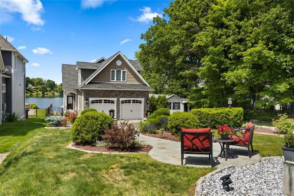a front view of a house with a garden
