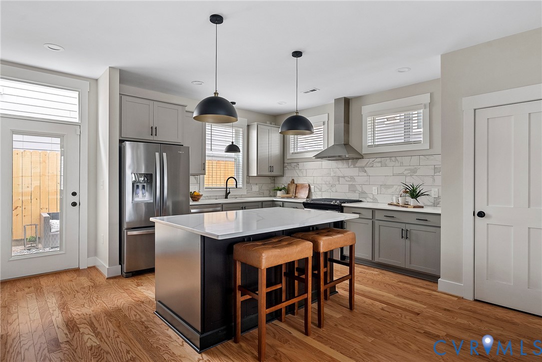 2909 R Street Richmond, VA 23223 - Photo 11 of 50 a kitchen with stainless steel appliances granite countertop wooden floors and sink