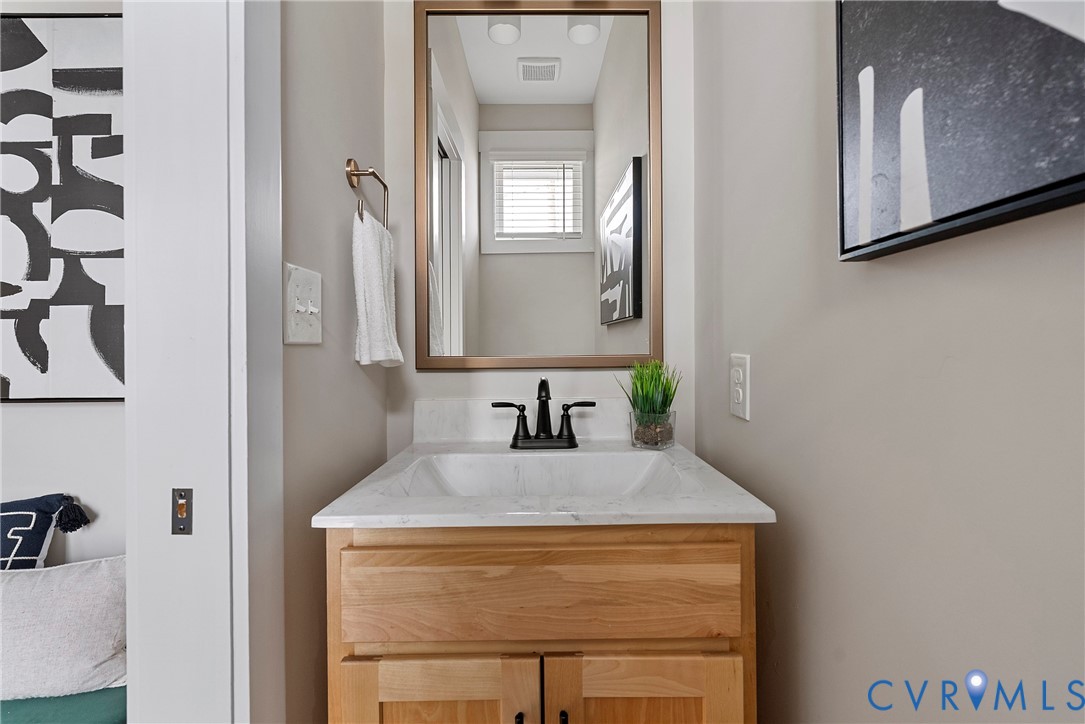 2909 R Street Richmond, VA 23223 - Photo 24 of 50 a bathroom with a sink and a mirror