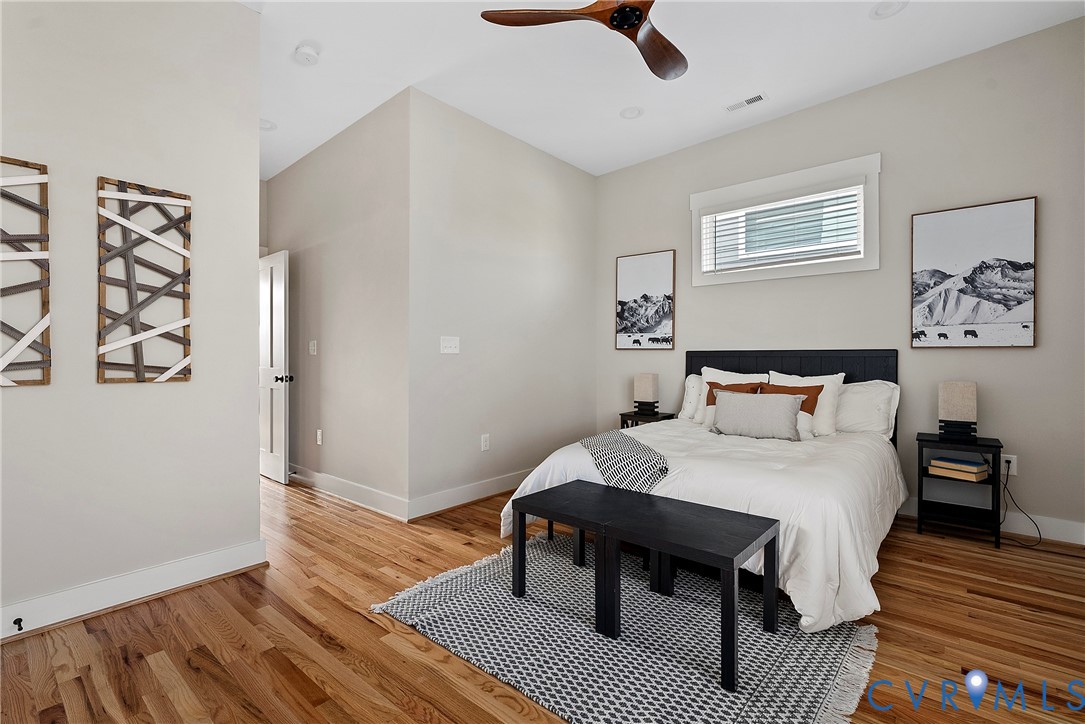 2909 R Street Richmond, VA 23223 - Photo 27 of 50 a bedroom with a bed and wooden floor
