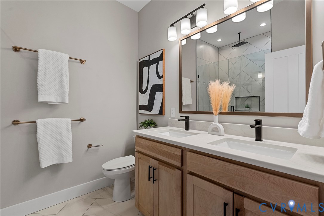 2909 R Street Richmond, VA 23223 - Photo 30 of 50 a bathroom with a toilet sink and mirror