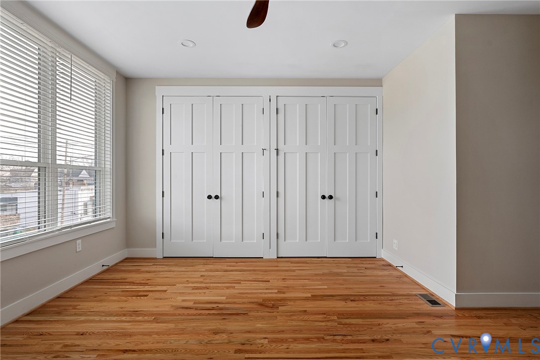 2909 R Street Richmond, VA 23223 - Photo 38 of 50 a view of an empty room with wooden floor and windows
