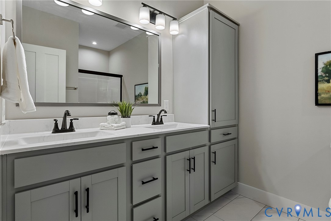 2909 R Street Richmond, VA 23223 - Photo 39 of 50 a bathroom with double sink and a mirror