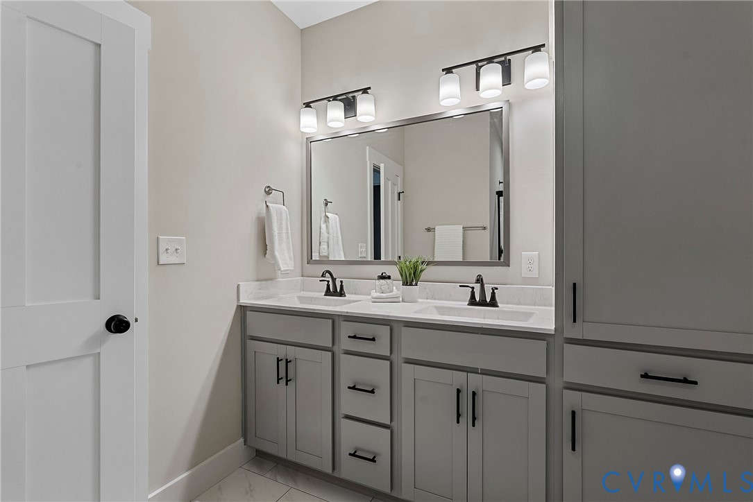 2909 R Street Richmond, VA 23223 - Photo 40 of 50 a bathroom with a double vanity sink and mirror