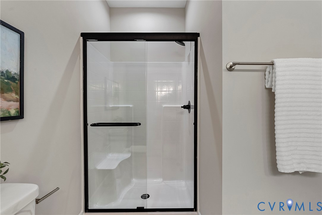 2909 R Street Richmond, VA 23223 - Photo 41 of 50 a bathroom with a glass shower door
